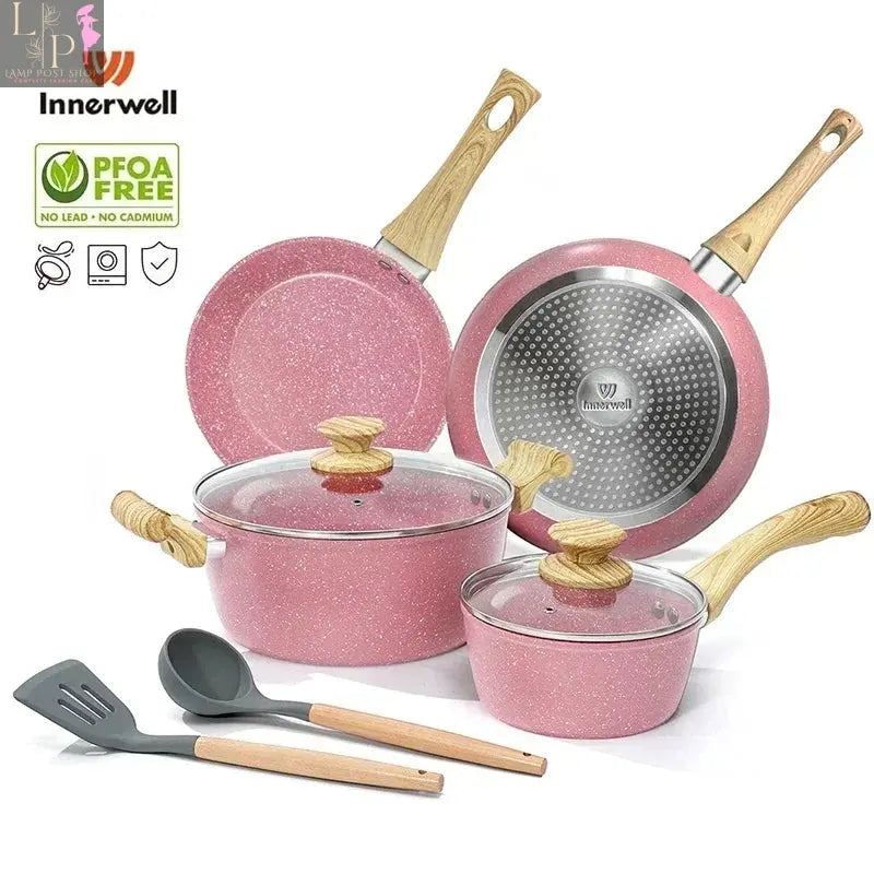 8-piece Lamp Post nonstick cookware set with glass lids and Bakelite handles, shown stacked on a kitchen counter.