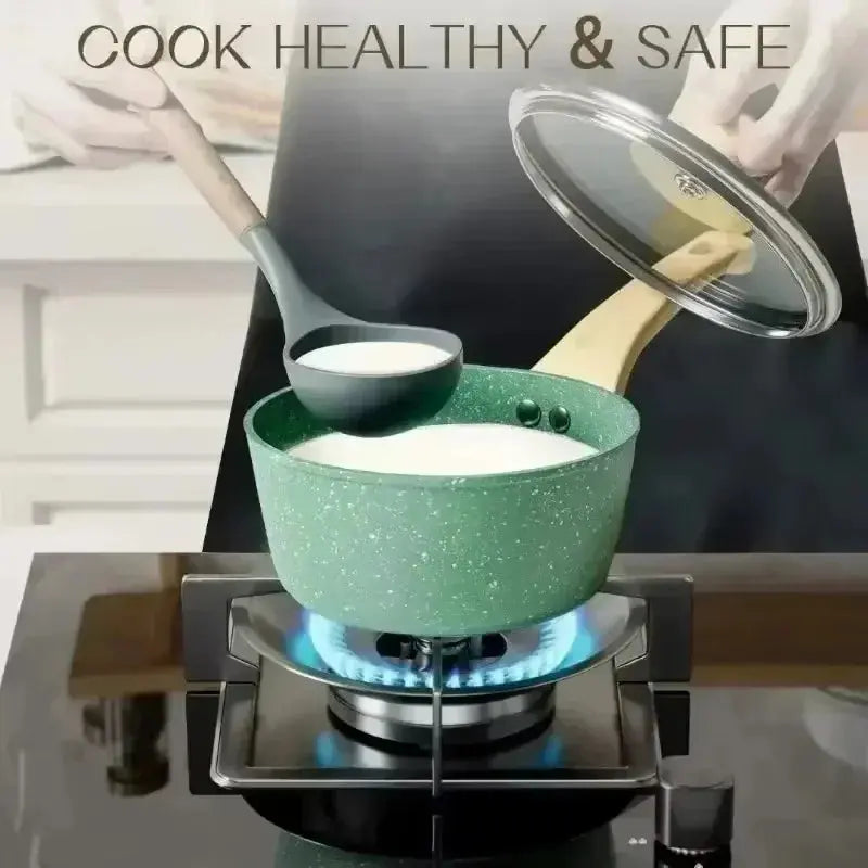 Pink Lamp Post nonstick 8-piece cookware set with lids, including frying pan, stockpot, and milk pot, displayed in a kitchen.