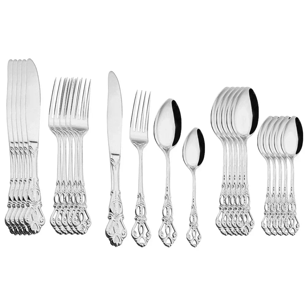 Golden stainless steel cutlery set from Lamp Post, 24-piece complete tableware with knives, forks, and spoons on a kitchen table.