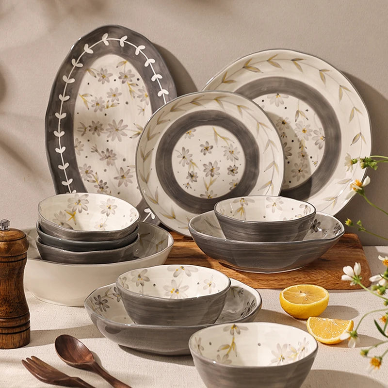 Lamp Post ceramic dining set with full dish cookware, including plates, bowls, and mugs, arranged on a kitchen table.