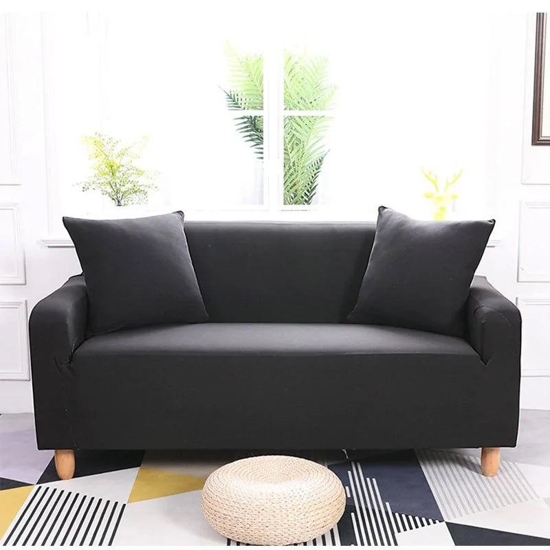 Lavender colorful sofa covers by Lamp Post draped over a sofa, showcasing vibrant fabric in a cozy living room setting.