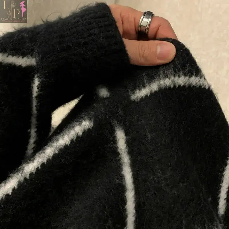 Stylish black men's sweater from Lamp Post, perfect for dressy occasions, shown as a large size on a model.