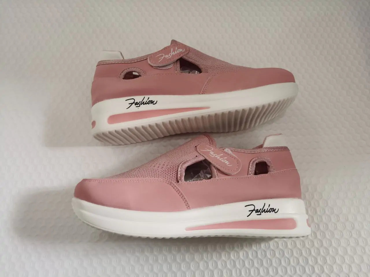 Pink women's sneakers by Lamp Post featuring a casual design and comfortable fit, shown on a white background.