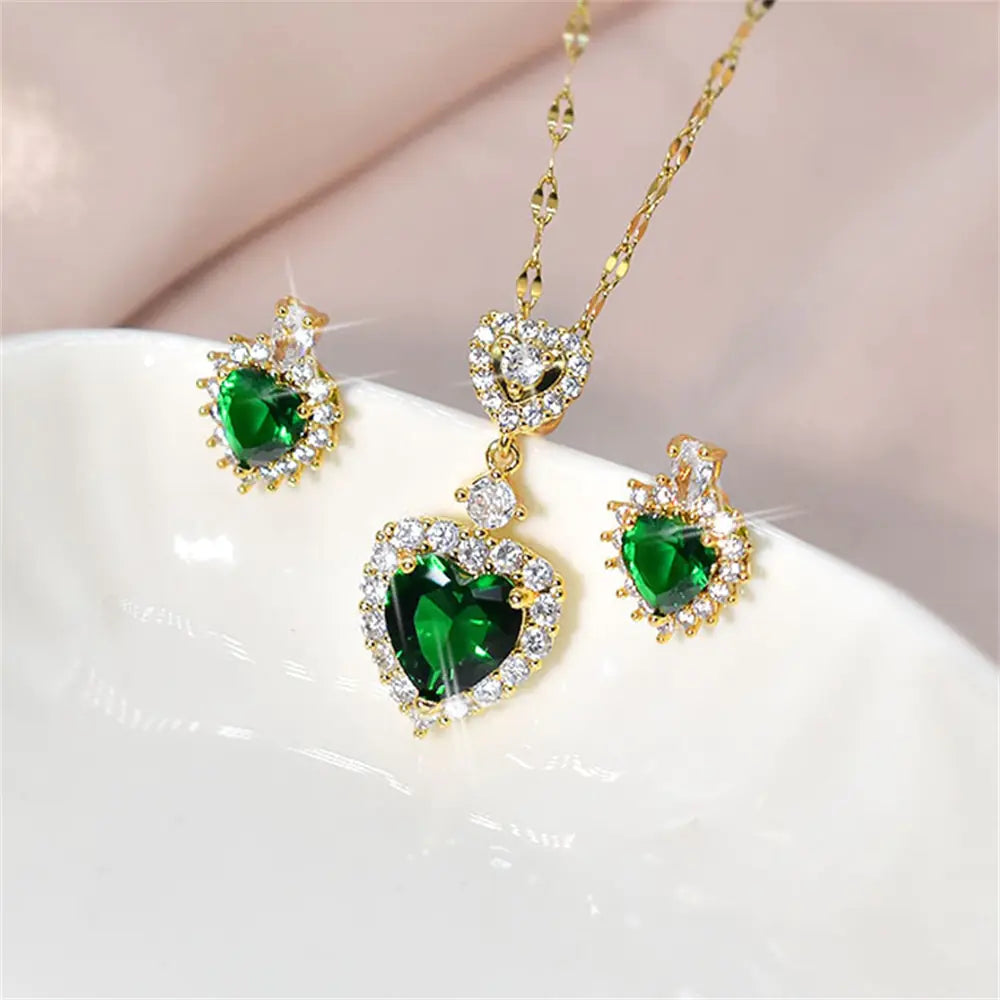 Women’s pink crystal jewelry set featuring a necklace and earrings by Lamp Post with sparkling heart-shaped details.