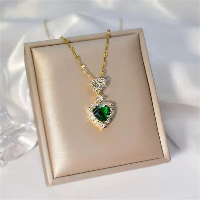 Women’s crystal jewelry set featuring pink heart-shaped earrings and necklace from Lamp Post. Elegant and sparkling accessory set.