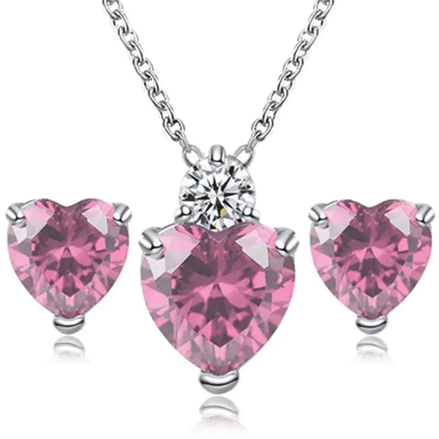 Pink crystal jewelry set for women featuring earrings and necklace from Lamp Post, elegant and sparkling accessory collection.