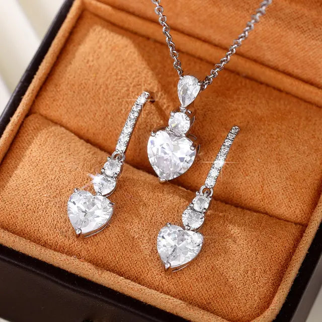 Women’s pink crystal jewelry set by Lamp Post featuring a heart-shaped pendant and matching earrings.