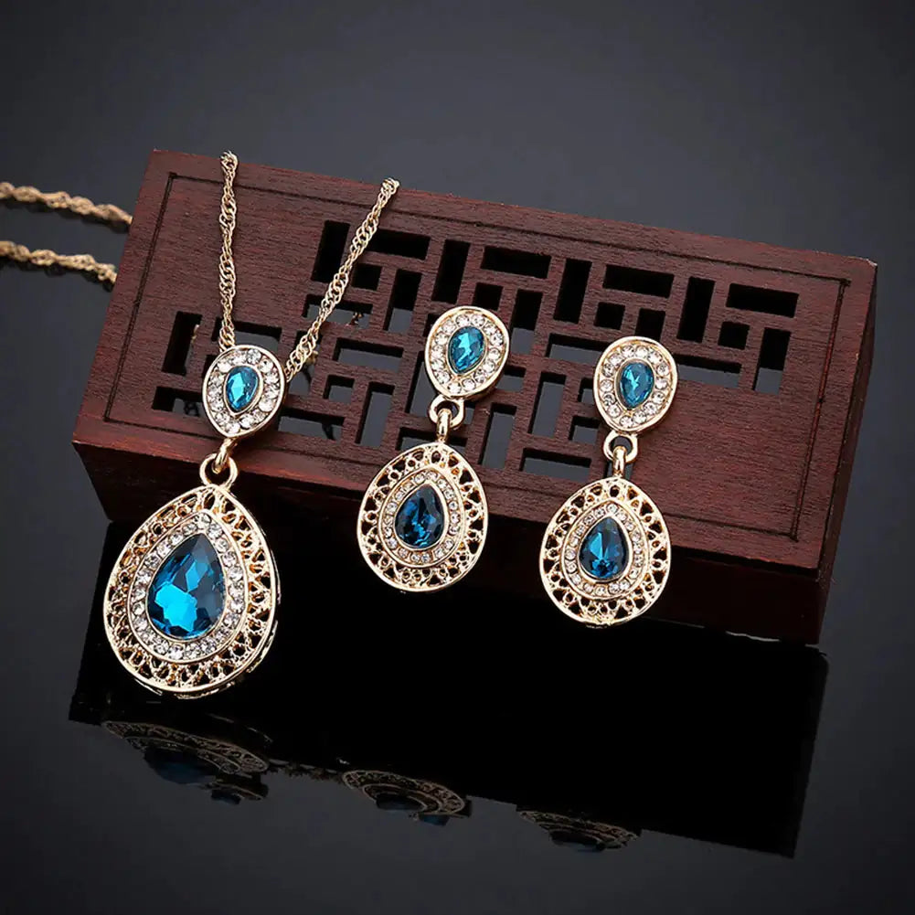 Red women's jewelry set by Lamp Post featuring earrings and a matching necklace with elegant design.