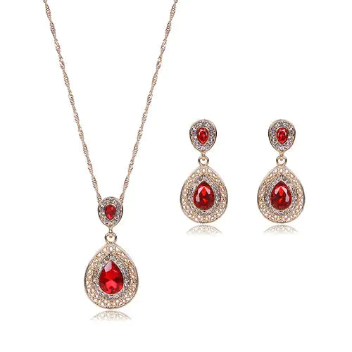 Red women jewelry set by Lamp Post featuring matching necklace and earrings with elegant design.