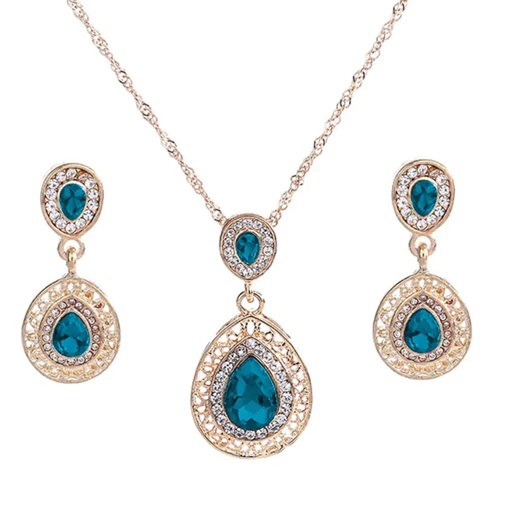 Red women jewelry set by Lamp Post featuring earrings and necklace with elegant design and matching accessories.