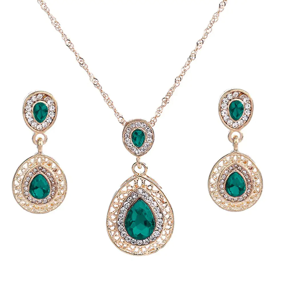 Red women jewelry set by Lamp Post featuring matching necklace, earrings, and bracelet with elegant design.
