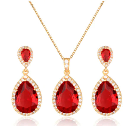 Red women jewelry set by Lamp Post featuring earrings and necklace with intricate design and elegant style.