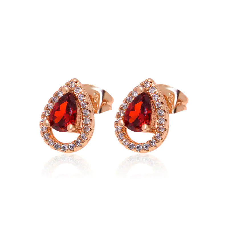 Red women jewelry set by Lamp Post featuring earrings and a matching necklace with elegant design.