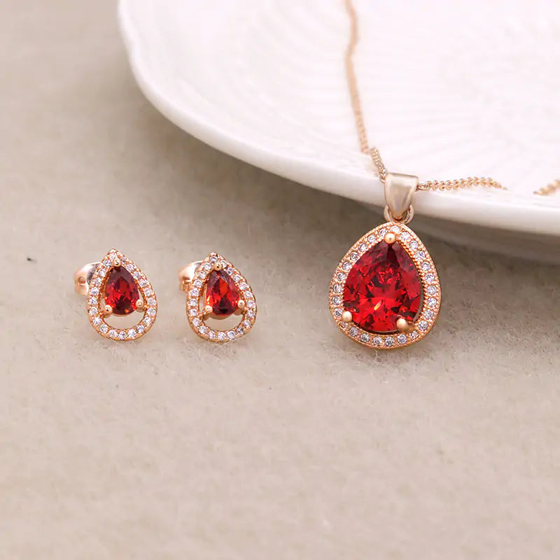 Red women's jewelry set by Lamp Post featuring earrings and a matching necklace with elegant design.