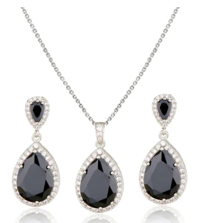 Red women jewelry set by Lamp Post featuring matching earrings and necklace with elegant design.