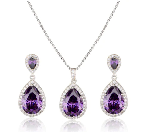 Women jewelry set by Lamp Post featuring a red necklace and matching earrings displayed on a white background.
