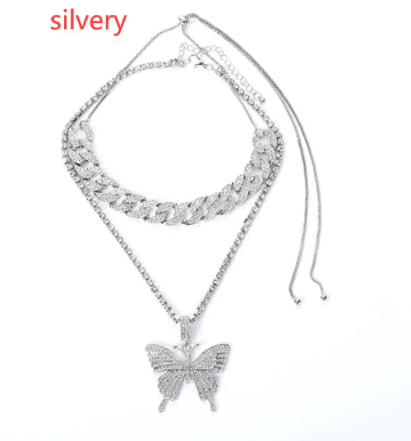 Silver women charm necklace set featuring layered chains and decorative charms, designed by Lamp Post.