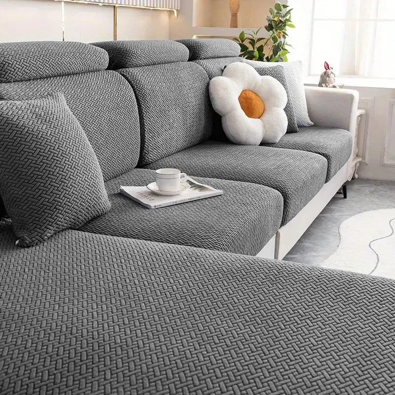 L-Shape sofa seat cushion cover by Lamp Post, protecting living room furniture with a coffee-colored fabric on a large sofa.