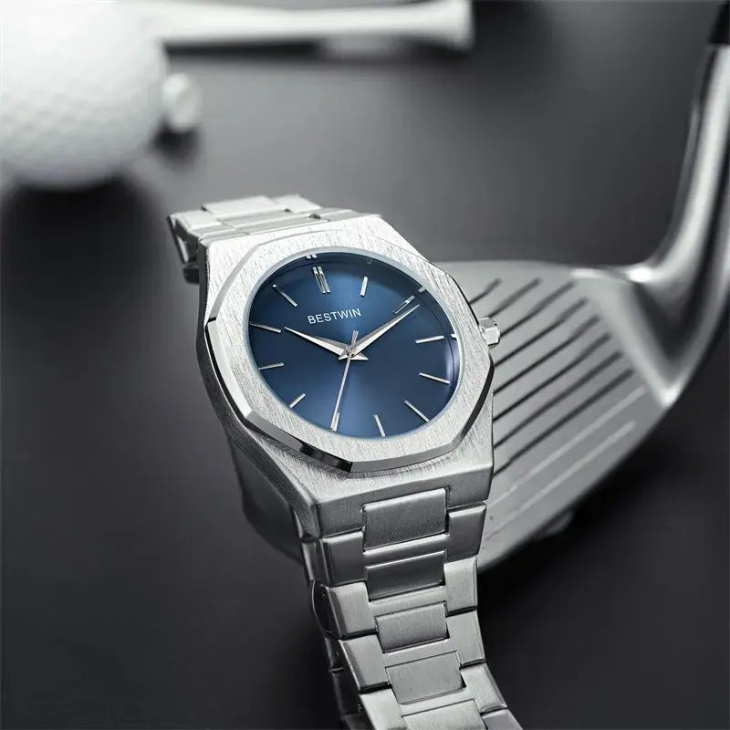 Stainless steel men's watch by Lamp Post with a gold and green dial, featuring a sleek and modern design.