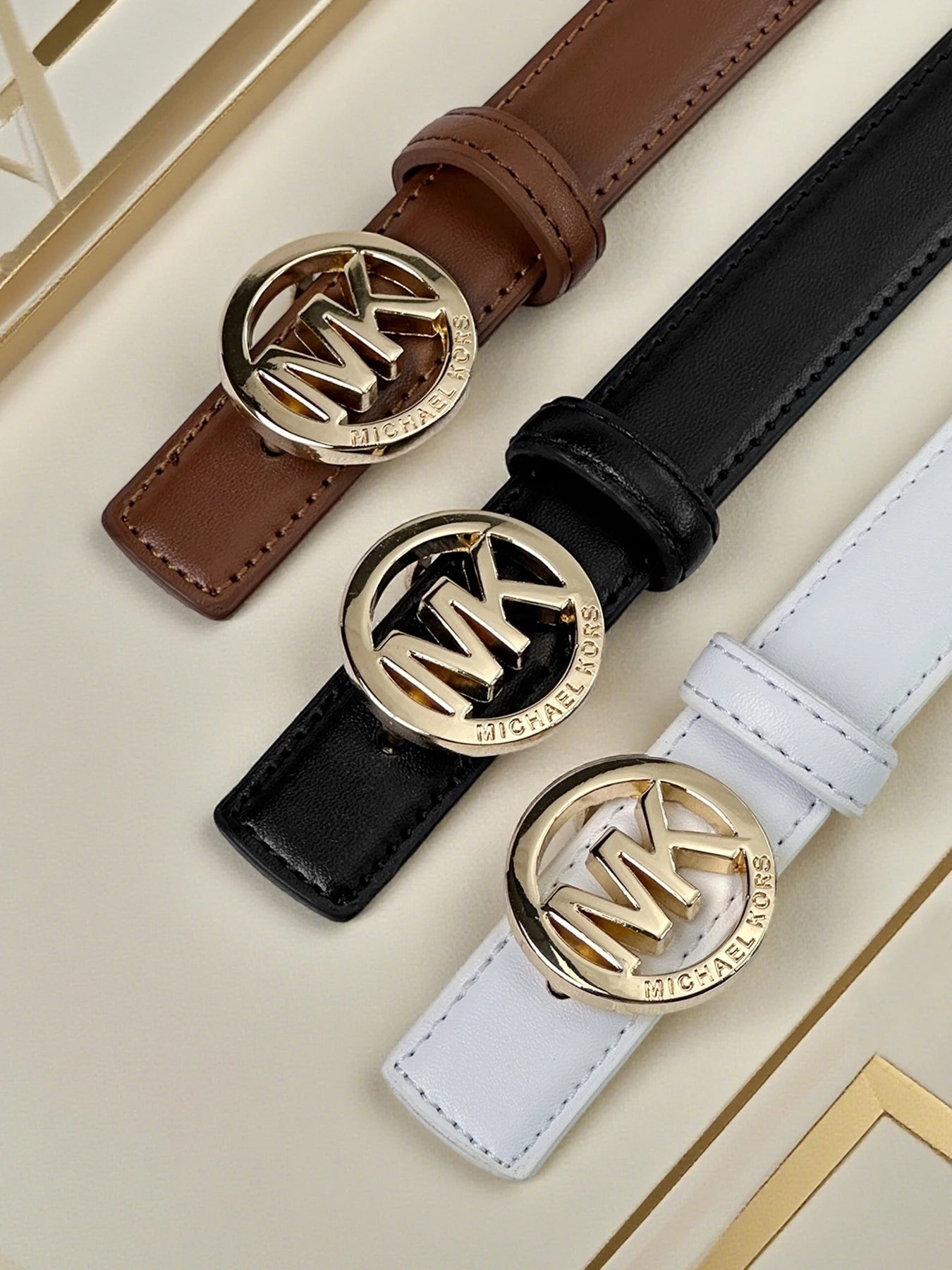 Elegant women's letter buckle belt by Lamp Post featuring premium textured leather and modern style, displayed on a white background.