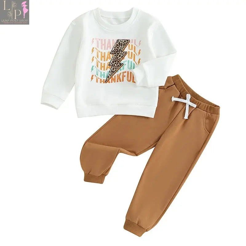 Baby girl or boy Thanksgiving outfit by Lamp Post featuring a white long-sleeve T-shirt, crewneck sweatshirt, and long pants.