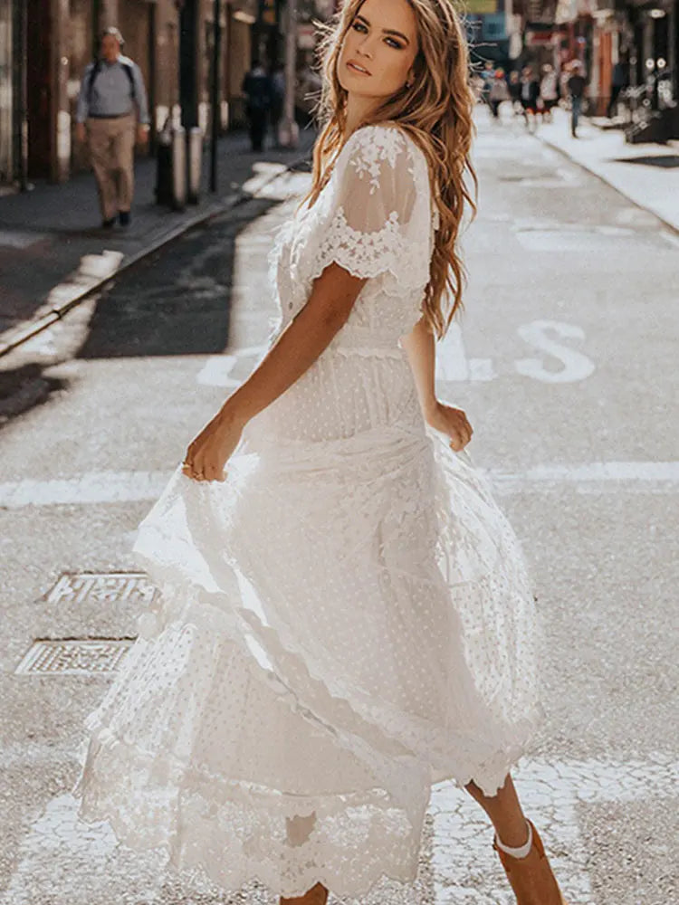 White women's long dress from Lamp Post featuring a flowing design and elegant style, shown on a model.