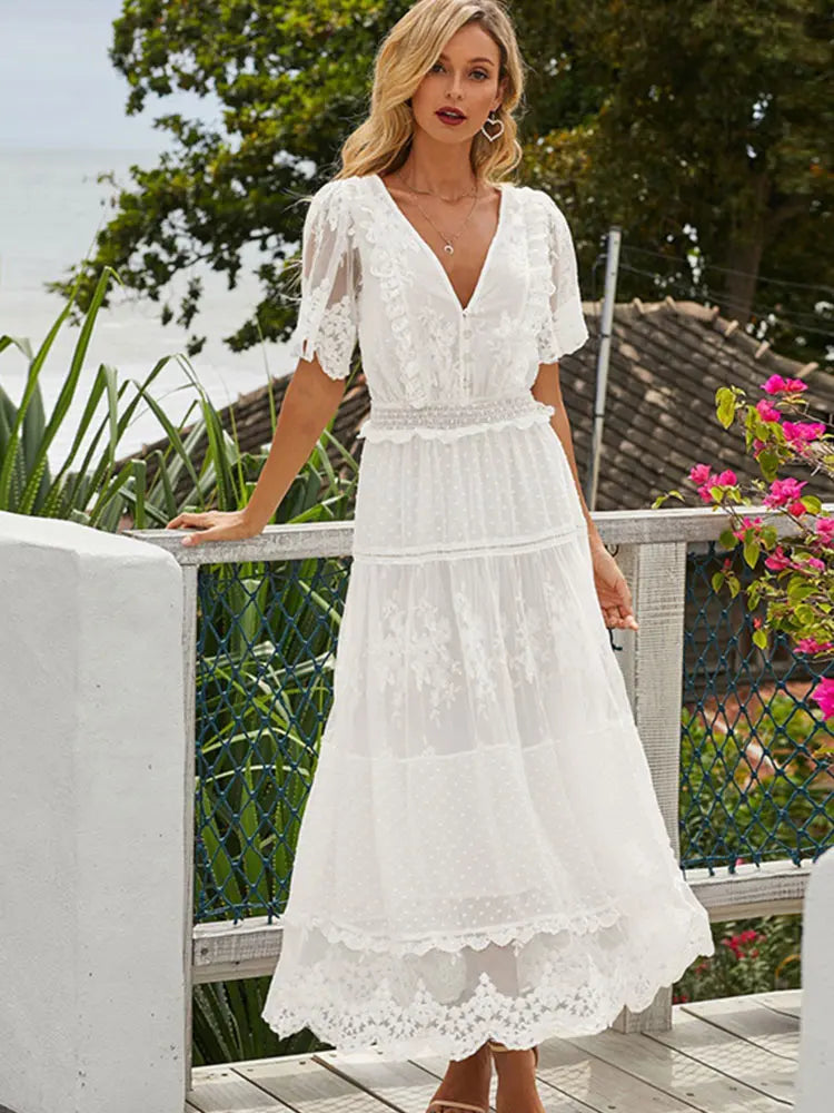 White women's long dress by Lamp Post, flowing fabric and elegant design, shown on a model in a full-length view.