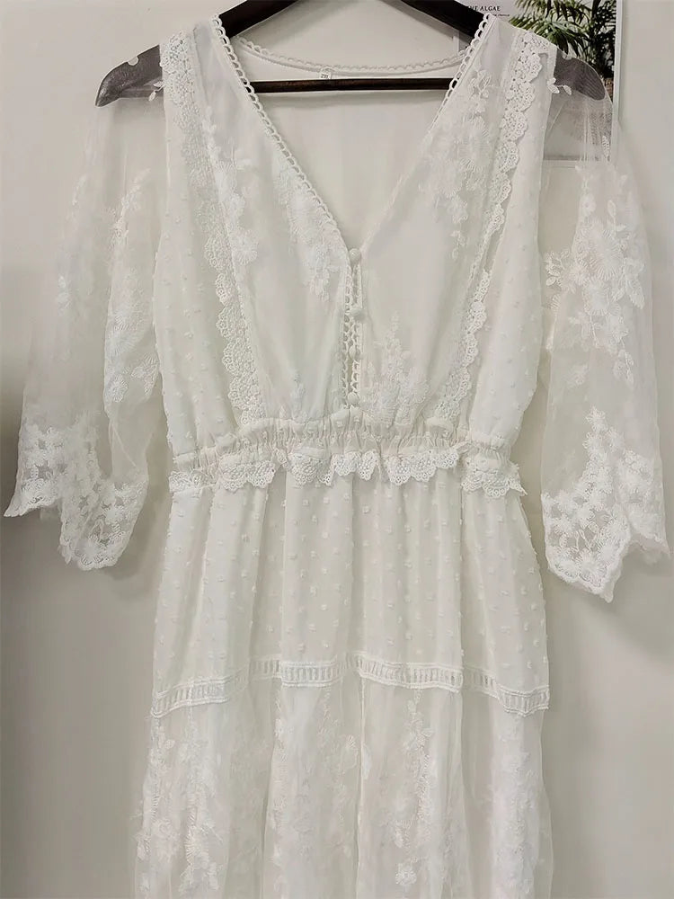 White women's long dress by Lamp Post, flowing and elegant, shown on a mannequin in a well-lit setting.