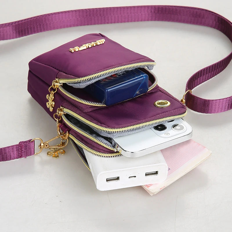 Black women's crossbody mini phone bag by Lamp Post, 20cm long, with coin pocket and neck hanging design for fashion and convenience.