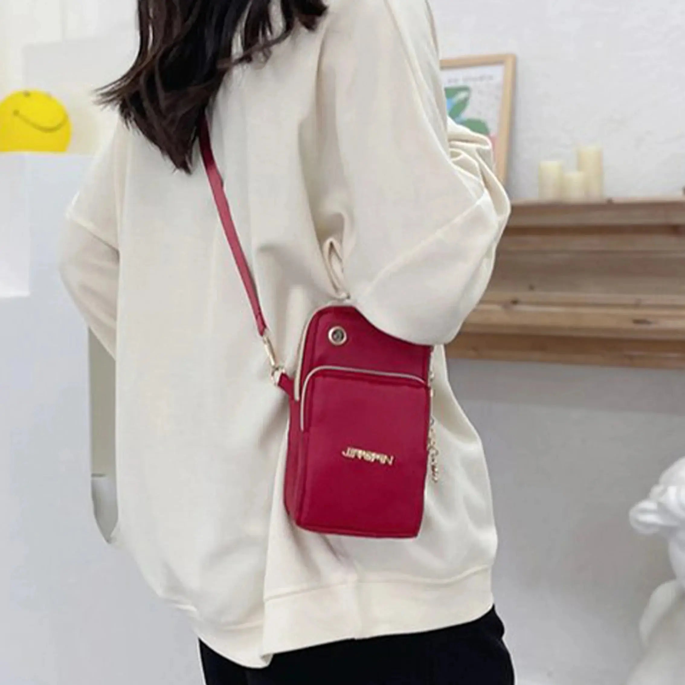 Black women's crossbody mobile phone bag by Lamp Post, mini size, 20cm length, with coin pocket and neck hanging design.