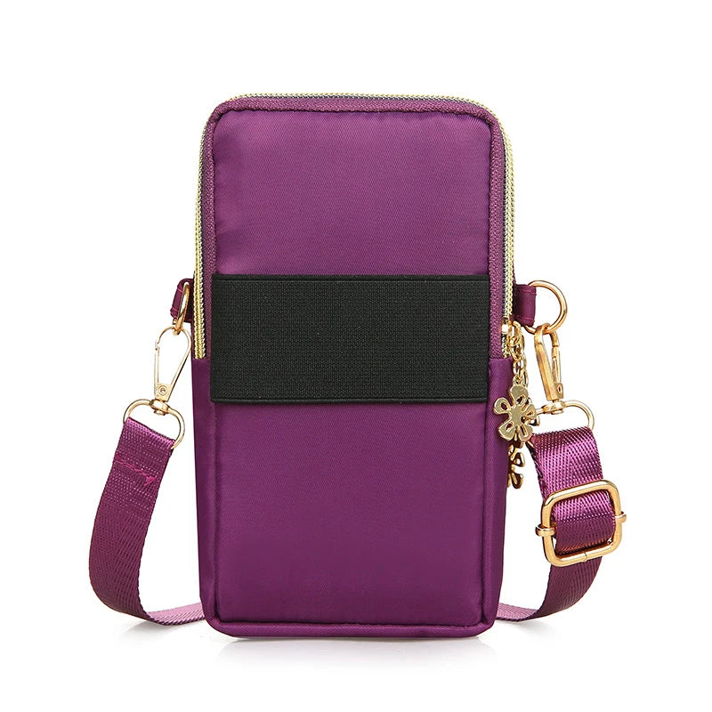 Black women's crossbody mobile phone bag by Lamp Post, compact mini bag with coin pocket, ideal for running or everyday use.
