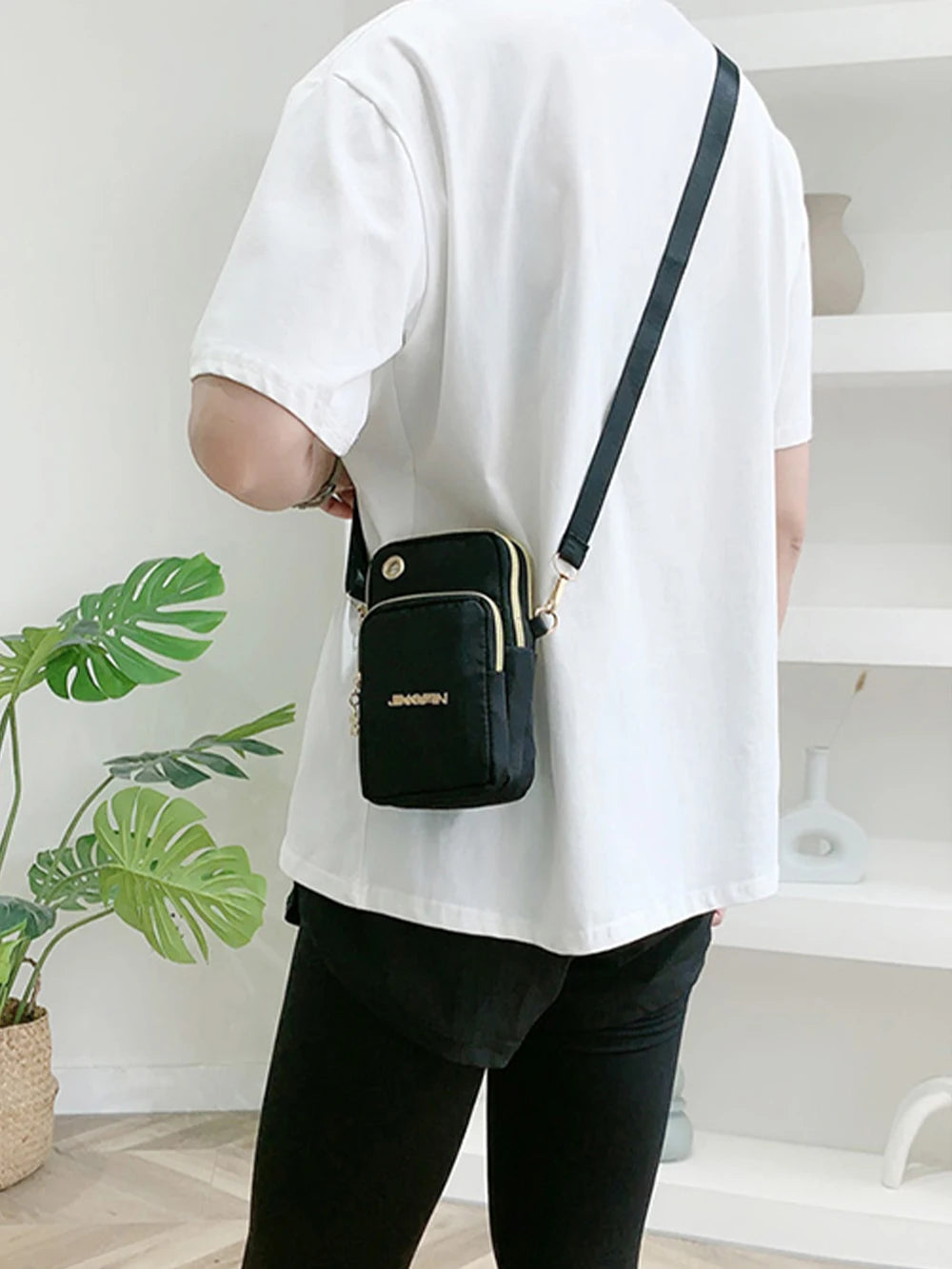 Black women's crossbody mini bag by Lamp Post, 20cm mobile phone bag with coin pocket, ideal for running and casual outings.