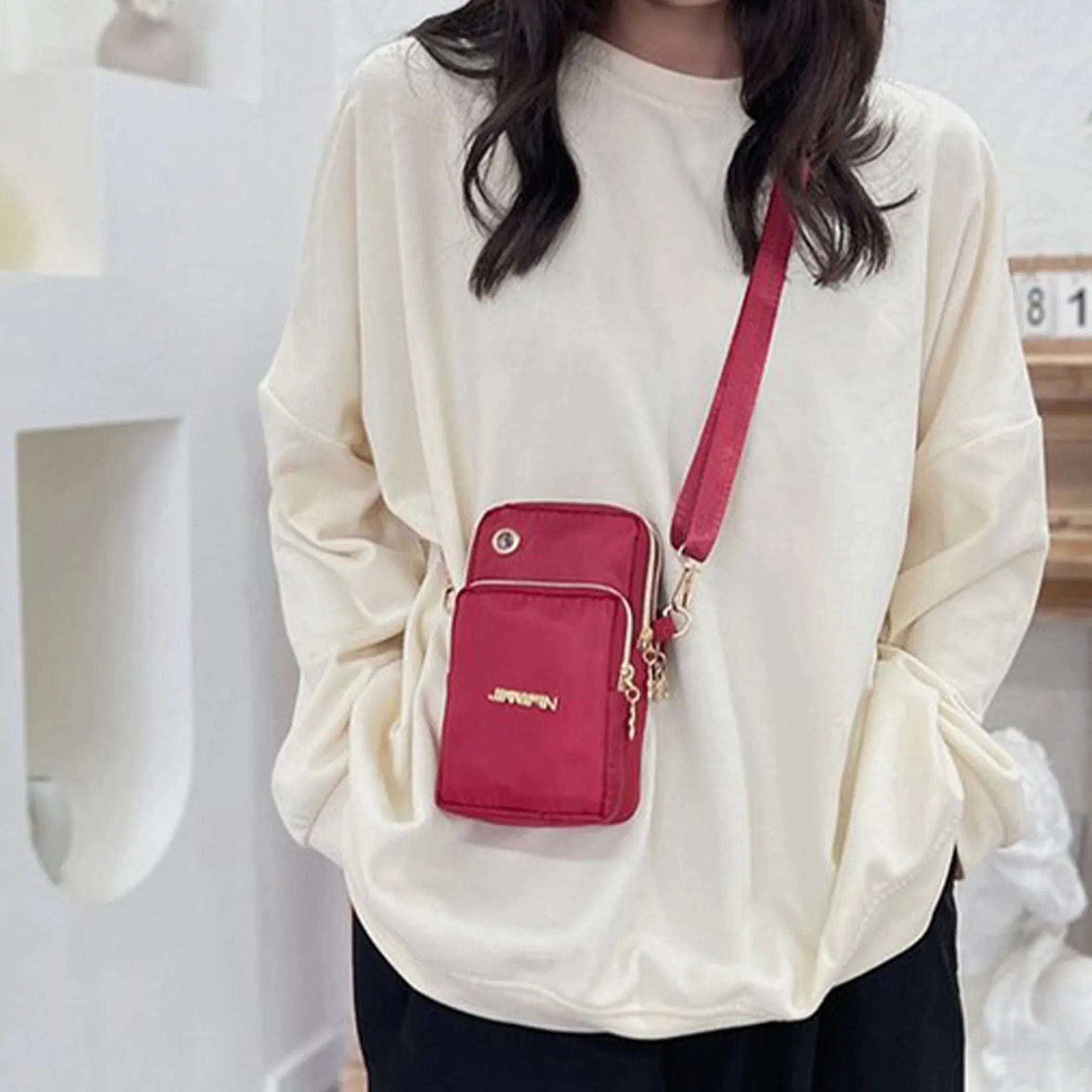 Black women's mini crossbody phone bag by Lamp Post, 20cm, with a strap for neck hanging, ideal for running and casual outings.
