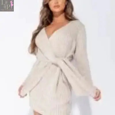 Beige Lamp Post women's wrapover knitted mini dress displayed on a hanger, showcasing its stylish design and texture.