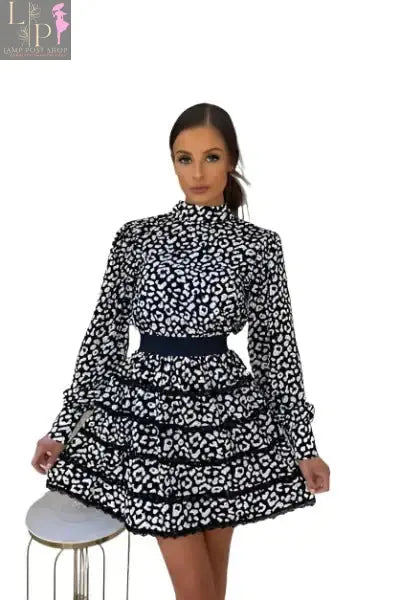 Black women’s mini dress by Lamp Post featuring a clinched waist and open back, perfect for stylish evening wear.