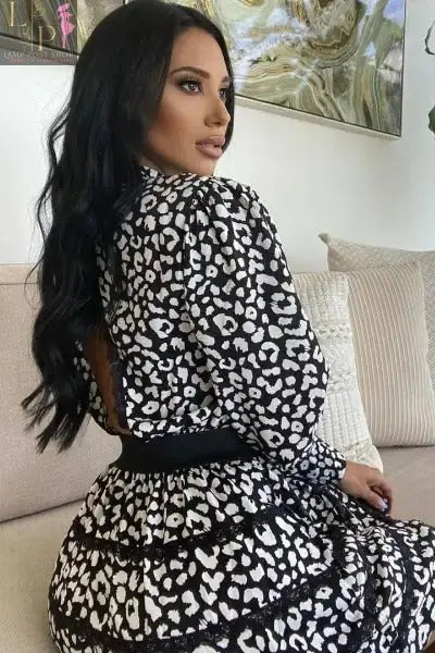 Black Lamp Post women's mini dress with clinched waist and open back, stylish and fitted for elegant occasions.