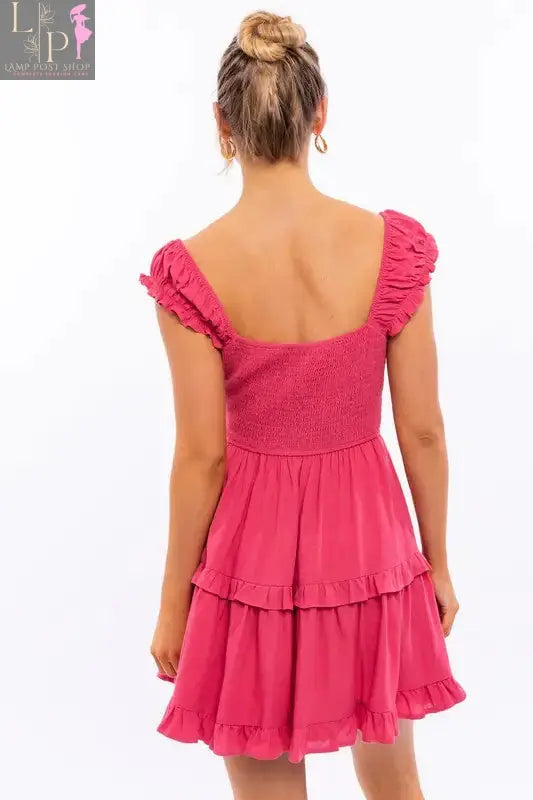 Pink Lamp Post women's cap sleeve ruffle mini dress with a fitted bodice and playful ruffle details, perfect for summer wear.