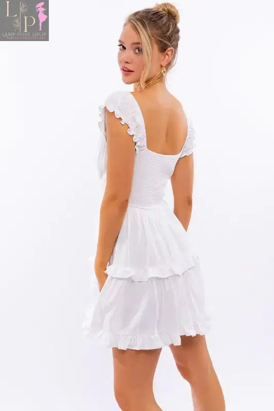 Pink cap sleeve ruffle mini dress for women by Lamp Post, featuring a flowy silhouette and feminine ruffle details.
