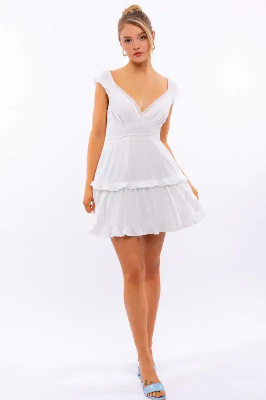 Pink Lamp Post women’s cap sleeve ruffle mini dress with a fitted bodice and playful ruffle details, perfect for summer wear.