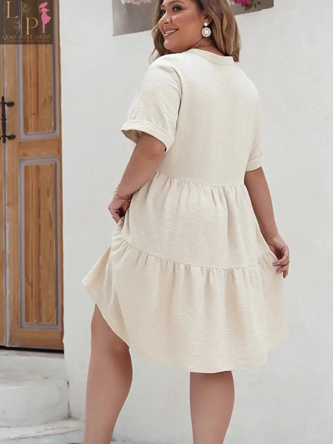 Plus size Sandy Dress by Lamp Post, a stylish women’s dress in sandy color, shown on a model, showcasing its flowy fabric and fit.