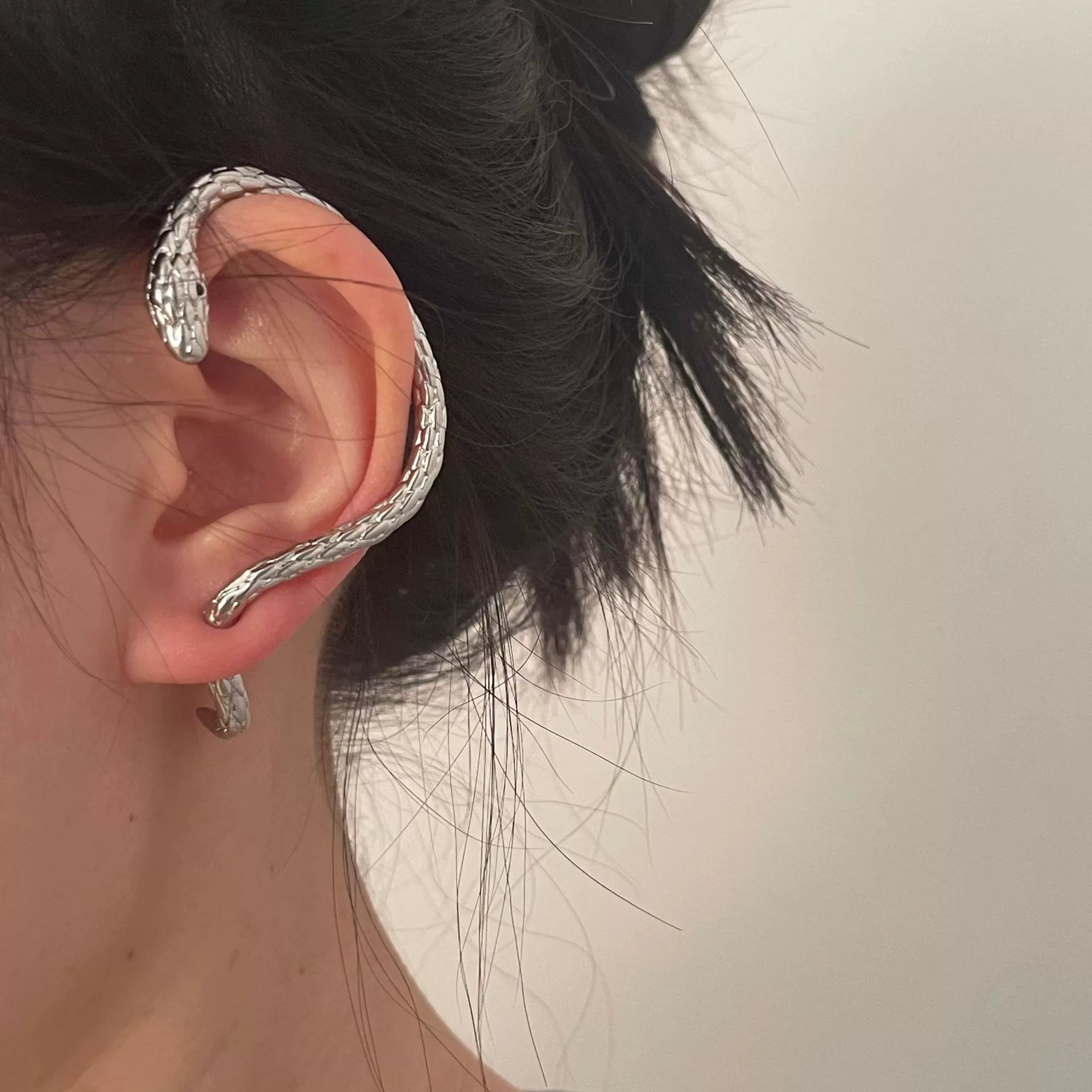 Snake shape ear hanging earrings for women by Lamp Post, featuring a stylish spirit snake design with ear holes.