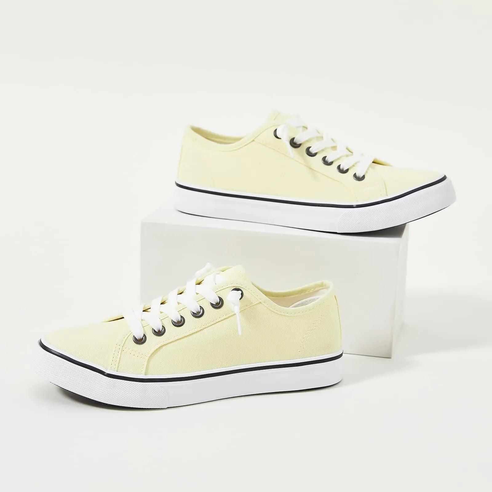 Yellow women’s canvas sneaker by Lamp Post with white rubber sole and casual style, perfect for everyday wear.