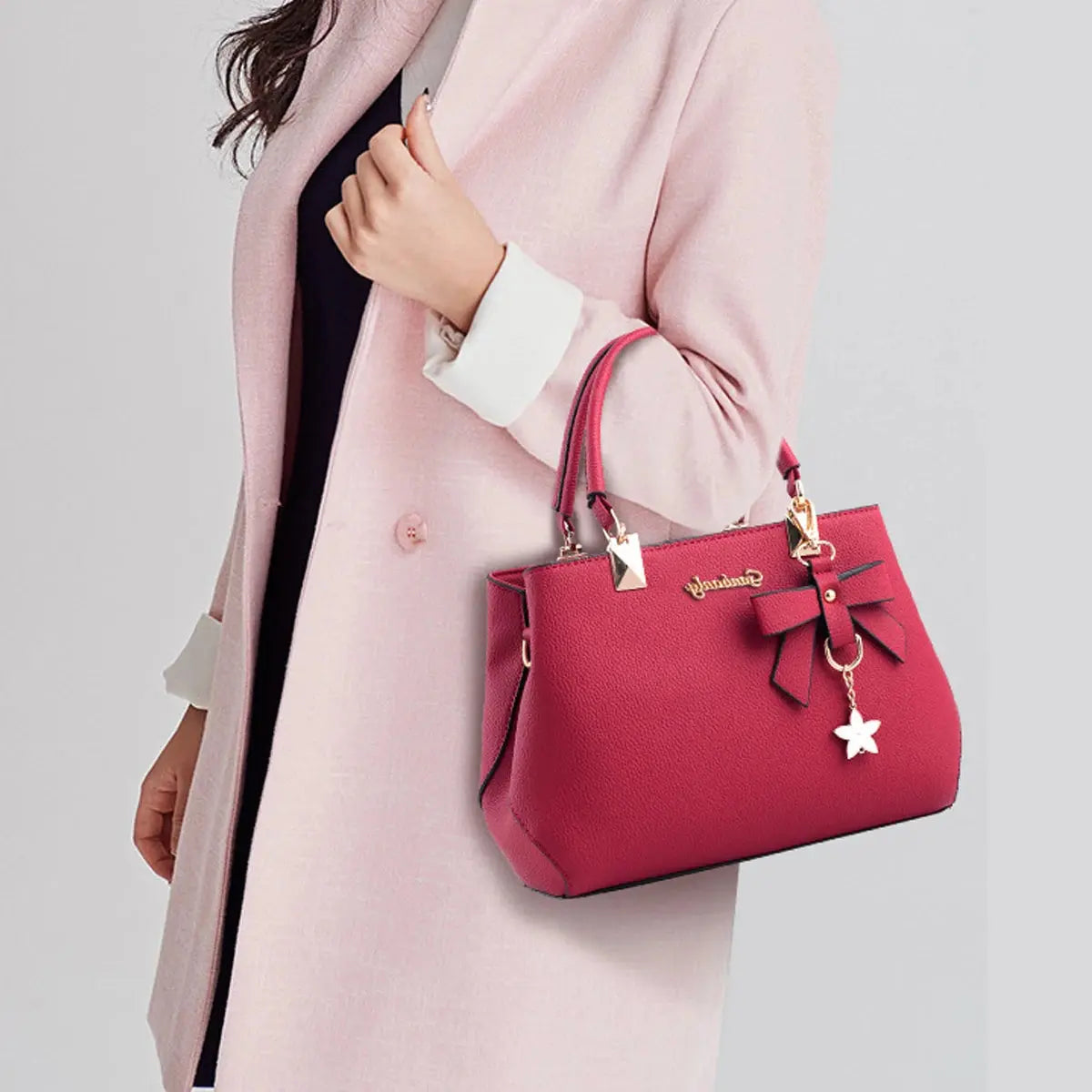 Pink classic elegant women's handbag with top handle and crossbody strap, stylish satchel bag and wallet combo.