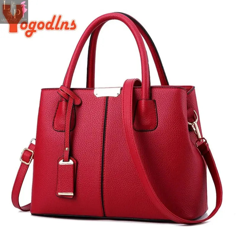 Leather designer women's handbag with pattern, luxury shoulder bag featuring a stylish, structured shape and gold-tone hardware.