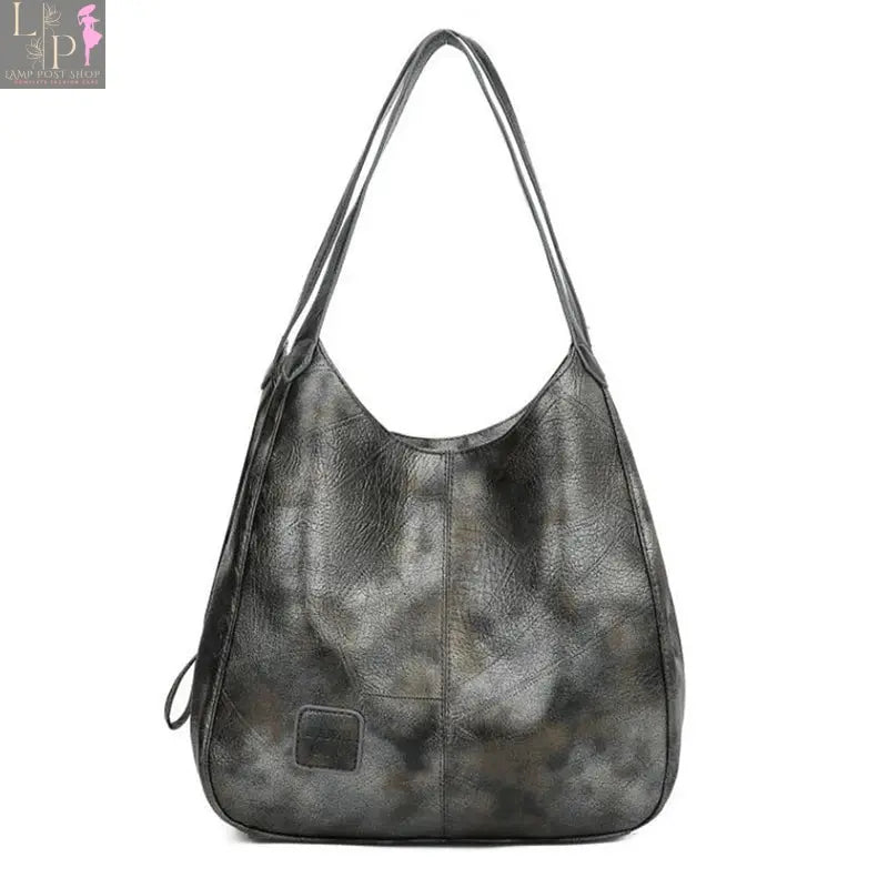 Vintage Yogodlns women's handbag with top handle, shoulder strap, and designer style in coffee color, showing front view.