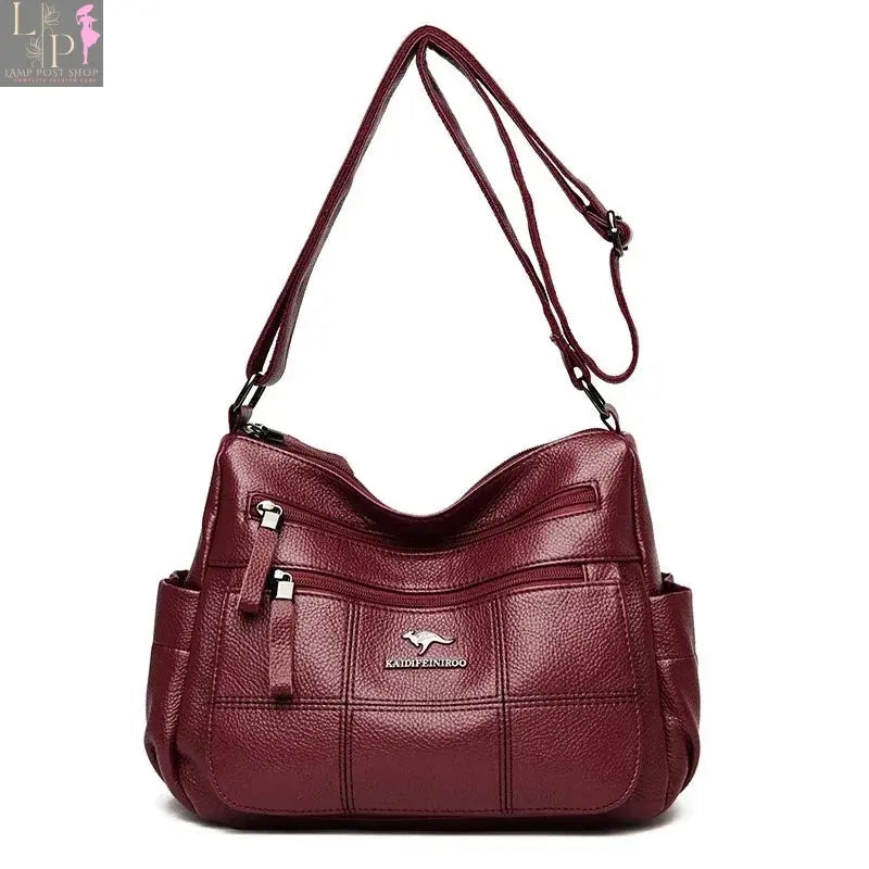 Green soft leather luxury handbag with 3 layers, shoulder strap, crossbody style, spacious tote for women.