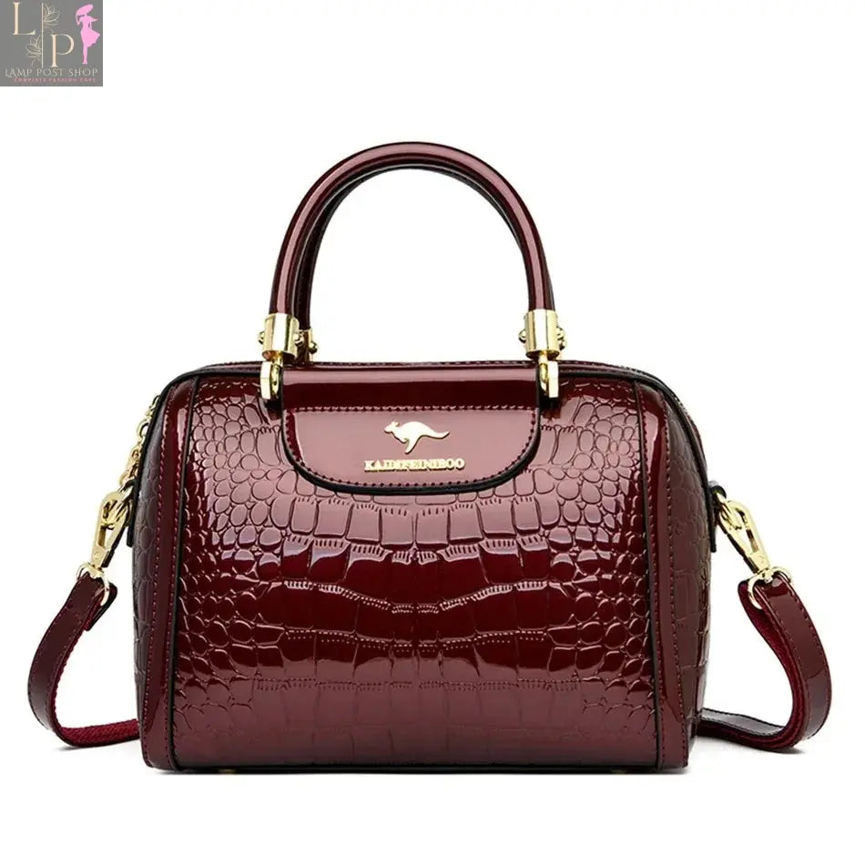 Green soft leather luxury handbag with multiple layers, shoulder strap, and spacious tote design for women.