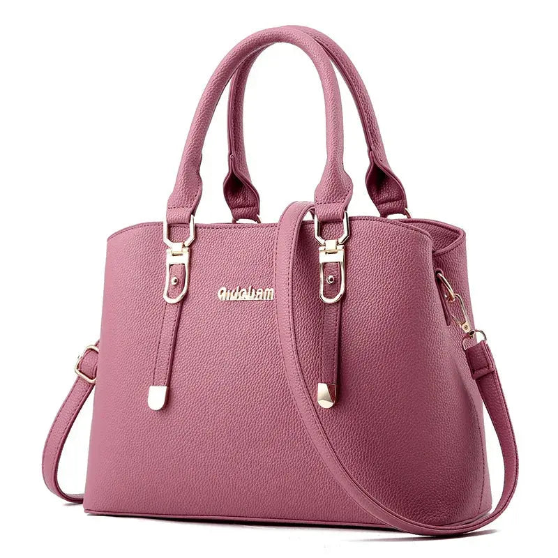 Leather women's casual tote bag with top handles in a neutral color, spacious design for everyday use.