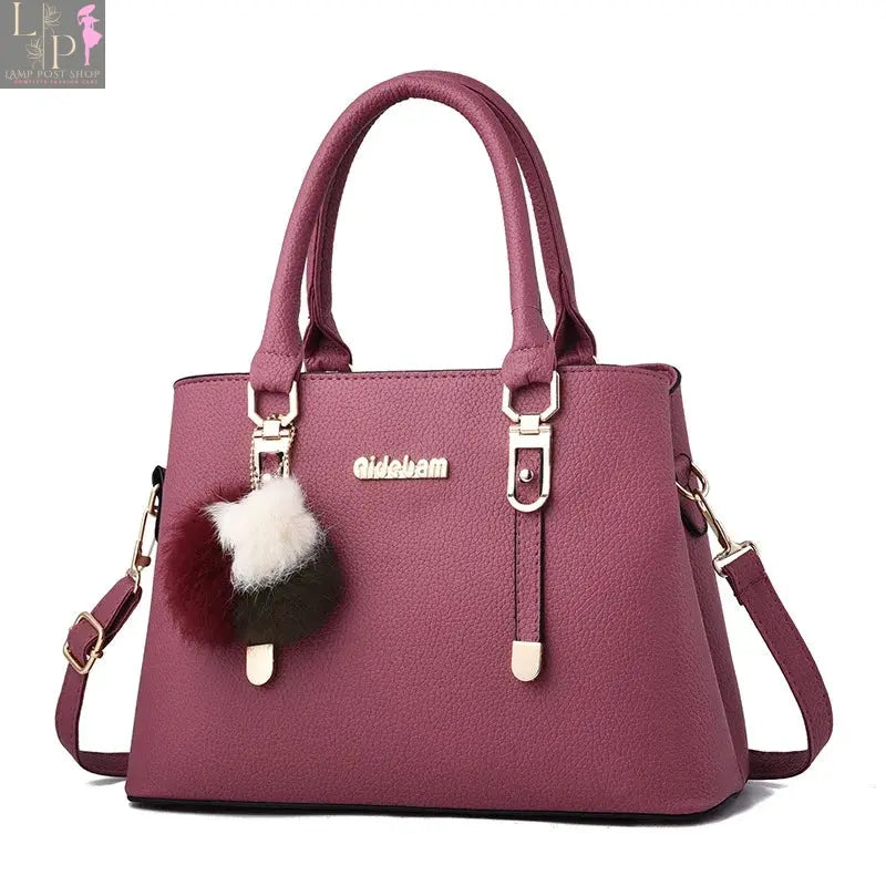 Leather women's casual tote bag in black with double handles and spacious interior, perfect for everyday use.