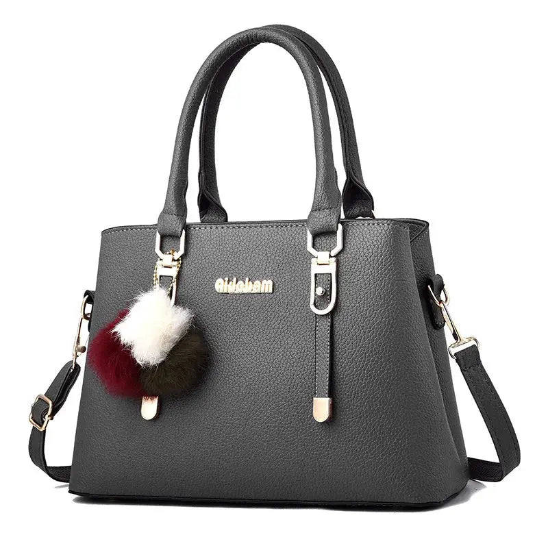 Leather women's casual tote handbag with sturdy handles and spacious interior, ideal for everyday use.